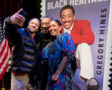 USPS issues Gregory Hines, the 42nd honoree in the Black Heritage Stamp Series. Event participants take selfies in front of the stamp.